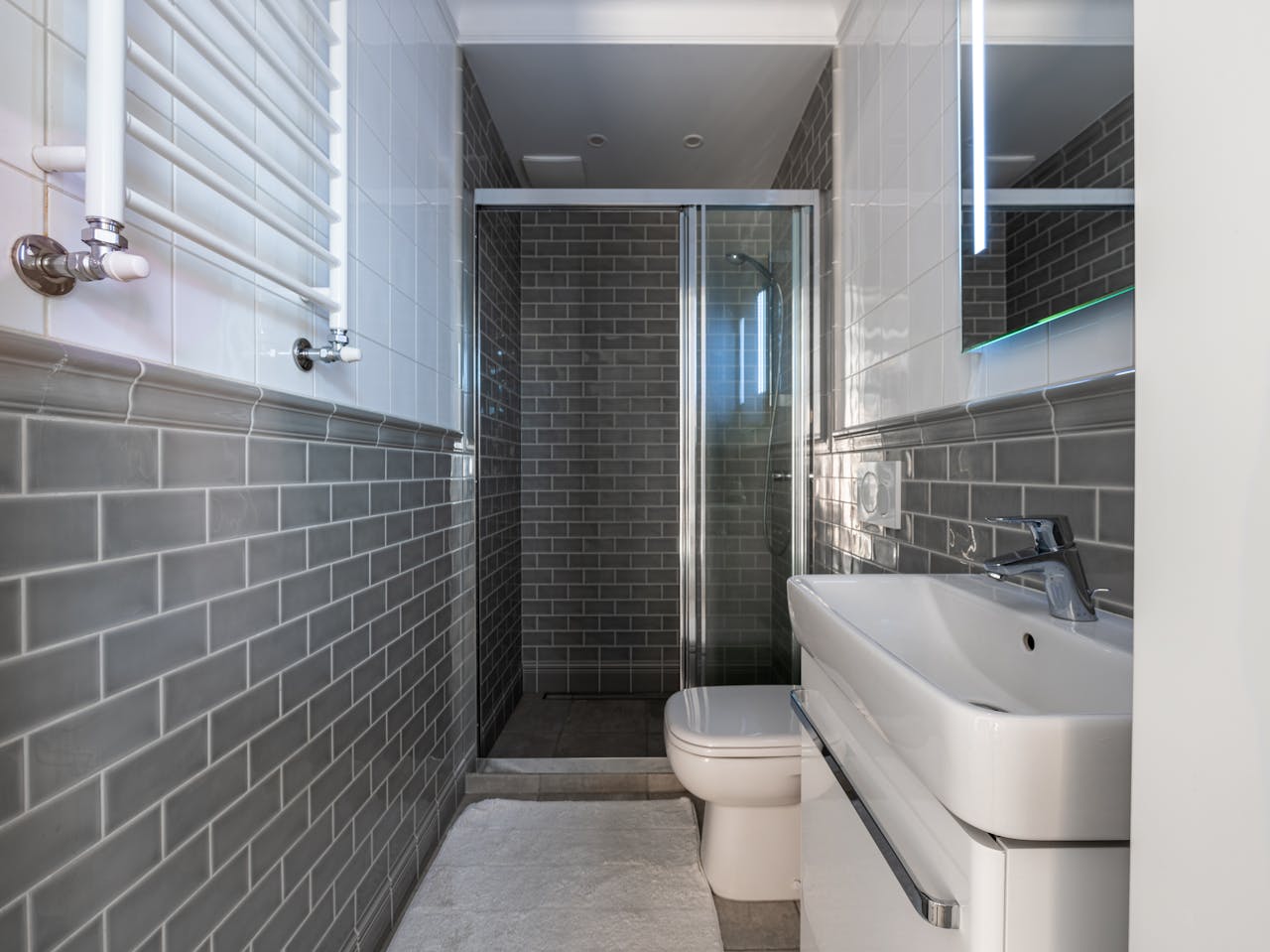 modern farmhouse bathroom renovation with subway tile shower and black fixtures